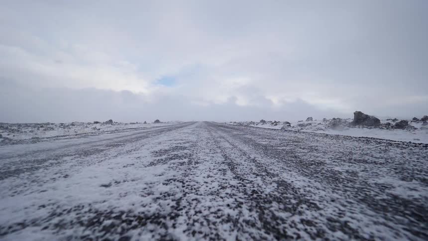 The wind blows snow across the ground