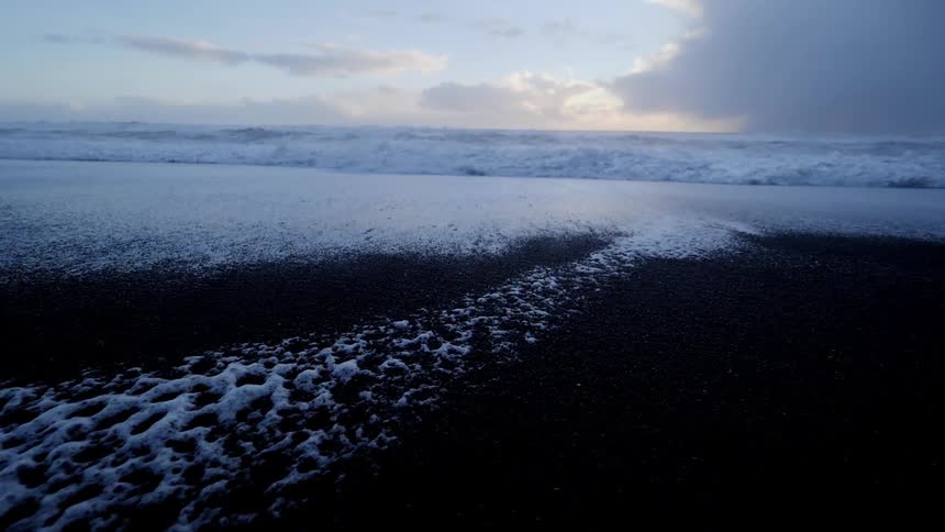 Foam bubbles on a sandy beach