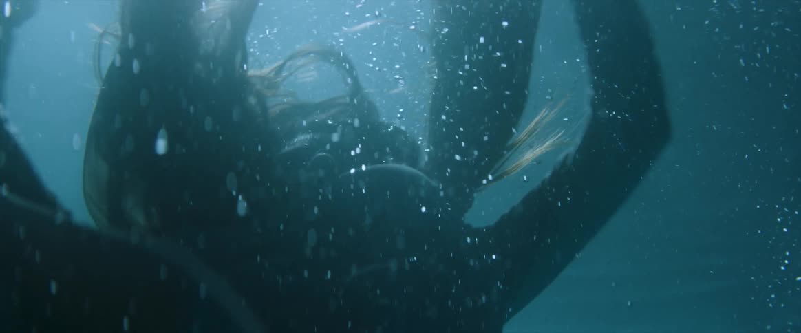 Woman struggling under water on a sunny day