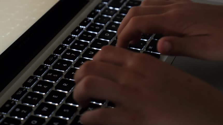 A person is using a keyboard on a laptop