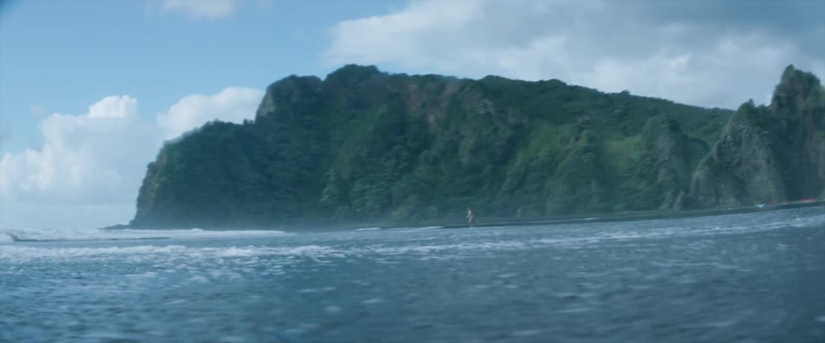 A person runs on a beach