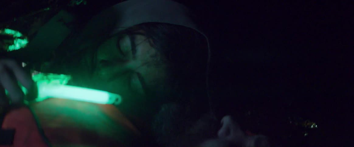 Two men sleeping in a cave have a night light