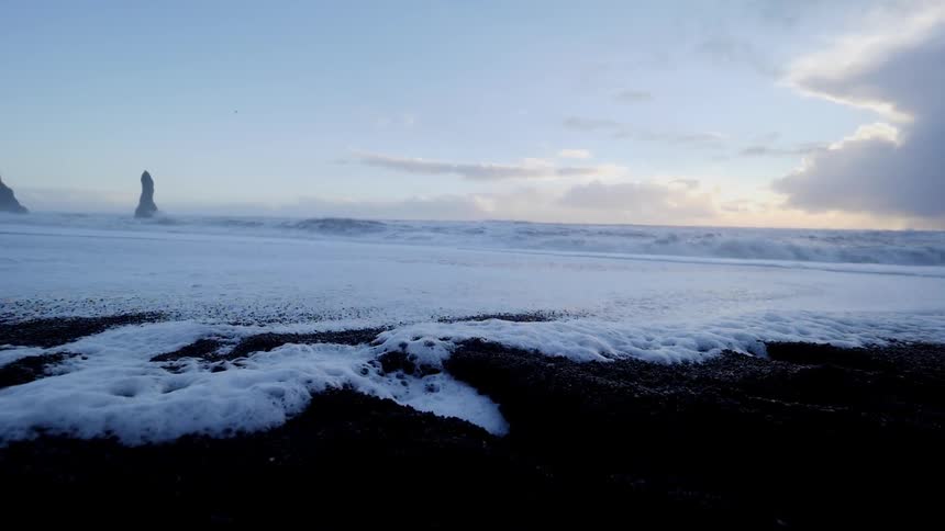 Frothy waves on a gravelly shore