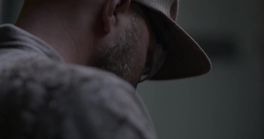 A man is looking down working on something