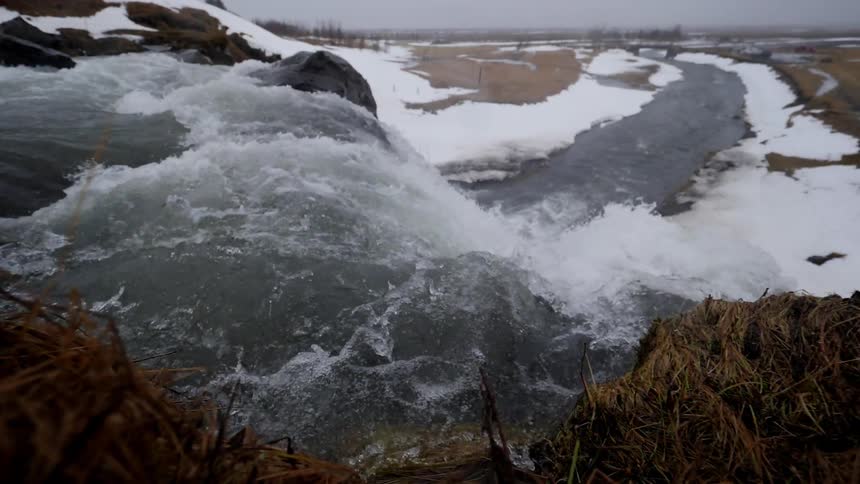 Icy water flows down a stream