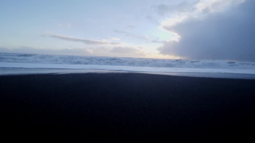 Tall waves crash onto the beach