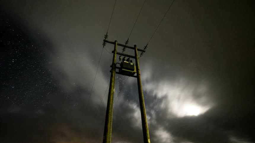 Clouds move fast over this power line