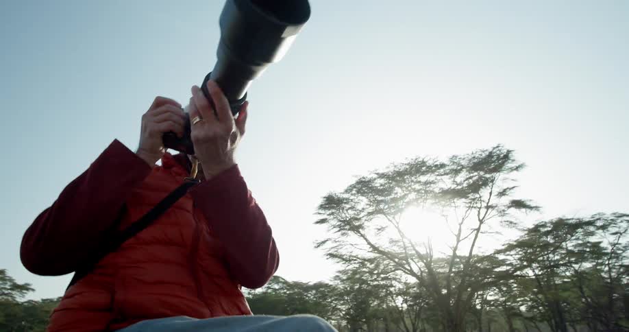 A photographer takes a picture while on a safari