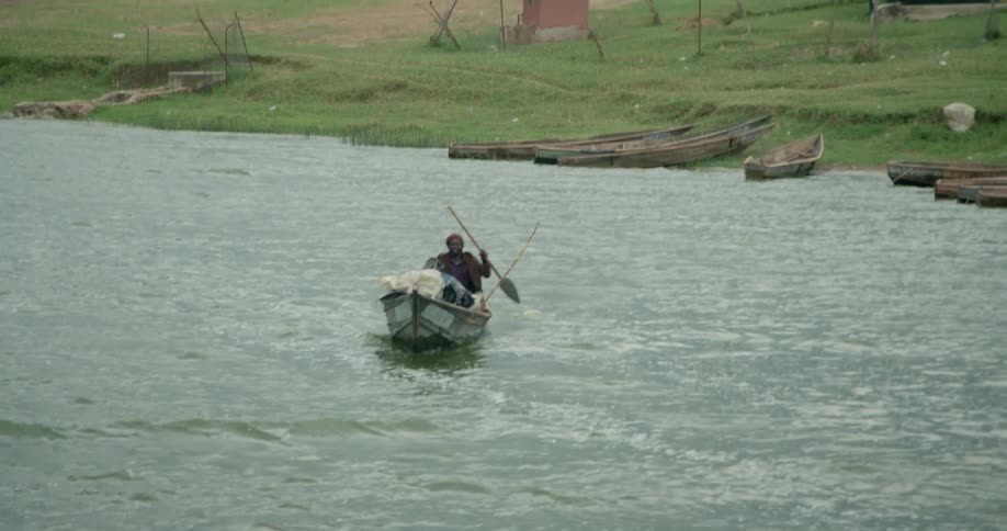 A man paddles a boat on a river