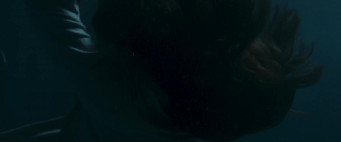 A woman sinks into the water