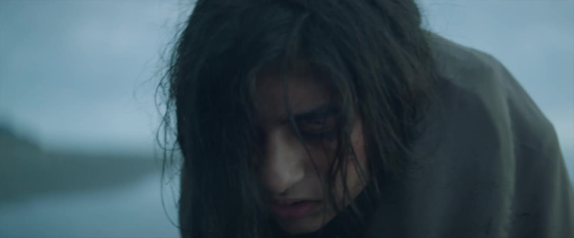 Cold woman wrapped in a blanket outside