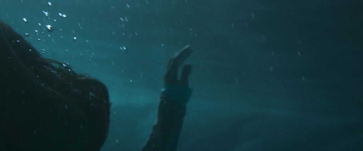 Woman sinks under the surface of the water