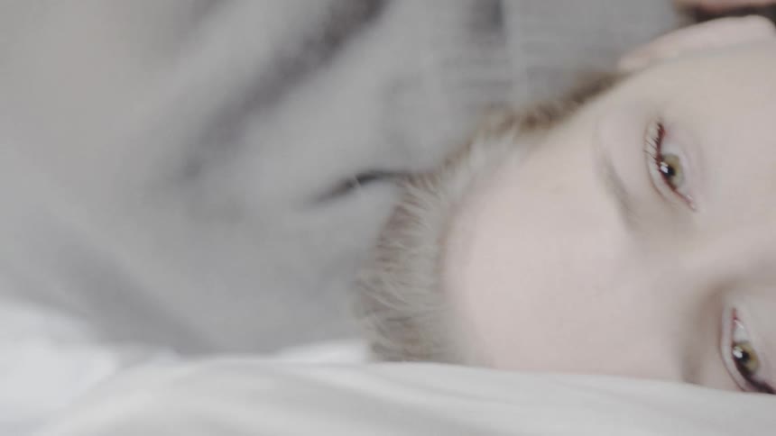 A woman is resting in bed