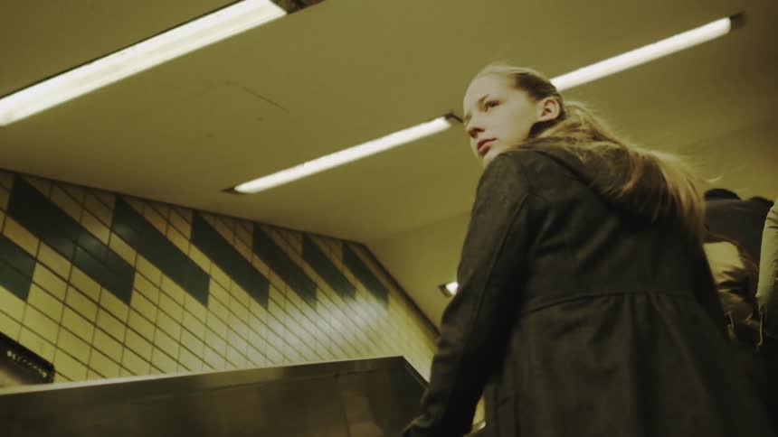 People riding up an escalator