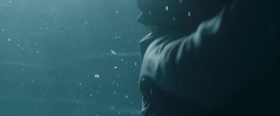 A fully clothed woman floats and struggles under water