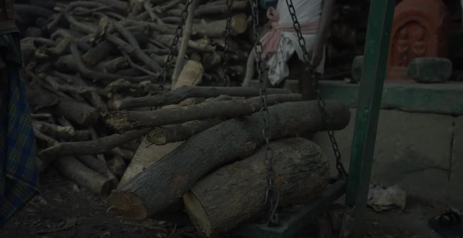 A chain swing carries stacked wood