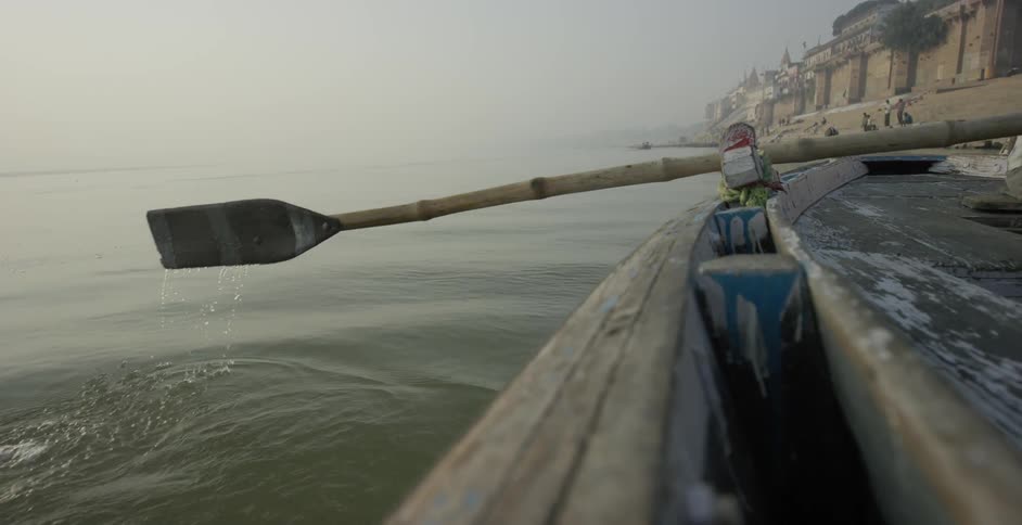 A person paddles a boat in the water