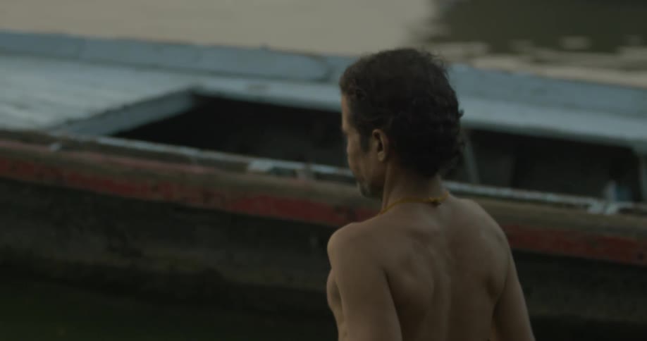 A man walks past a boat