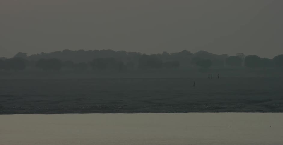 Past the water is a fog filled field