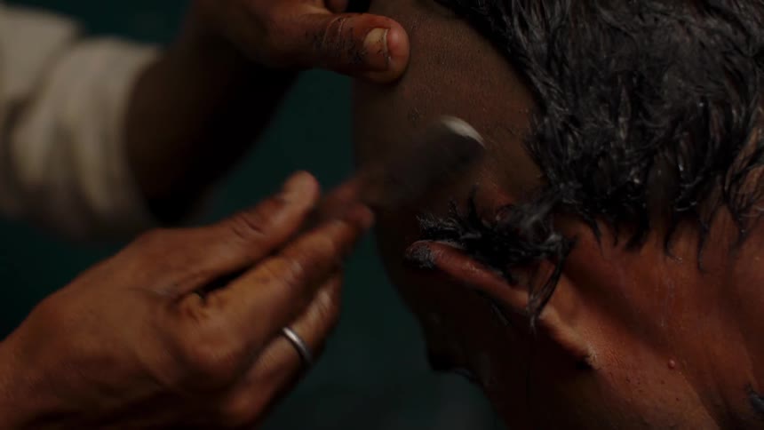 Man having his head shaved