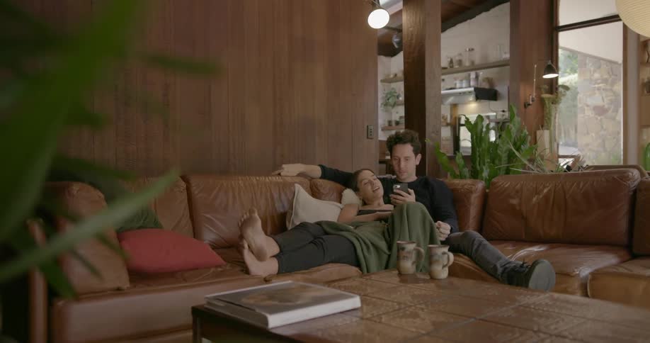 A couple sitting and looking at a phone