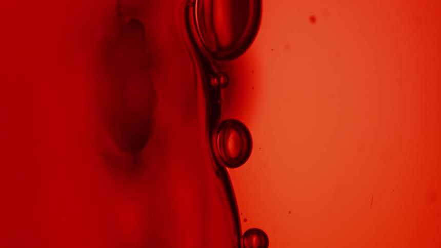 Bubbles floating through red liquid