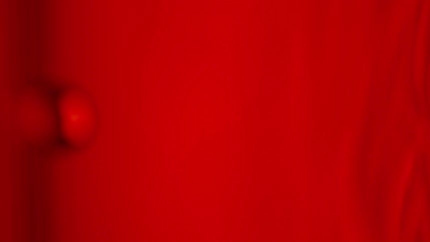 Bubbles floating through red liquid