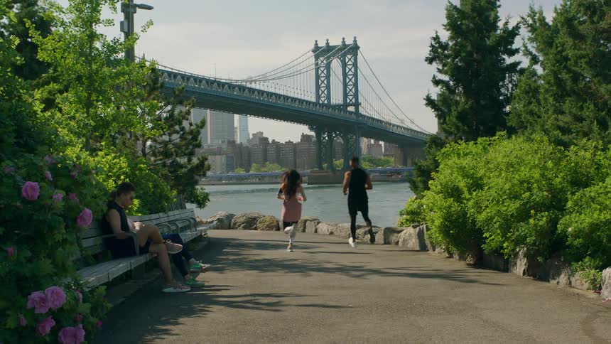 People jogging on a path near the water