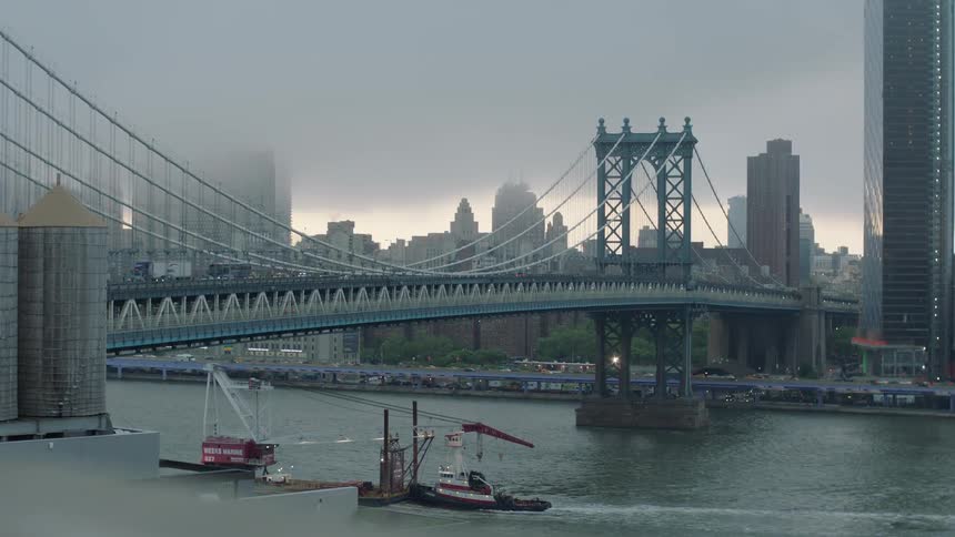Past the bridge has buildings covered with fog