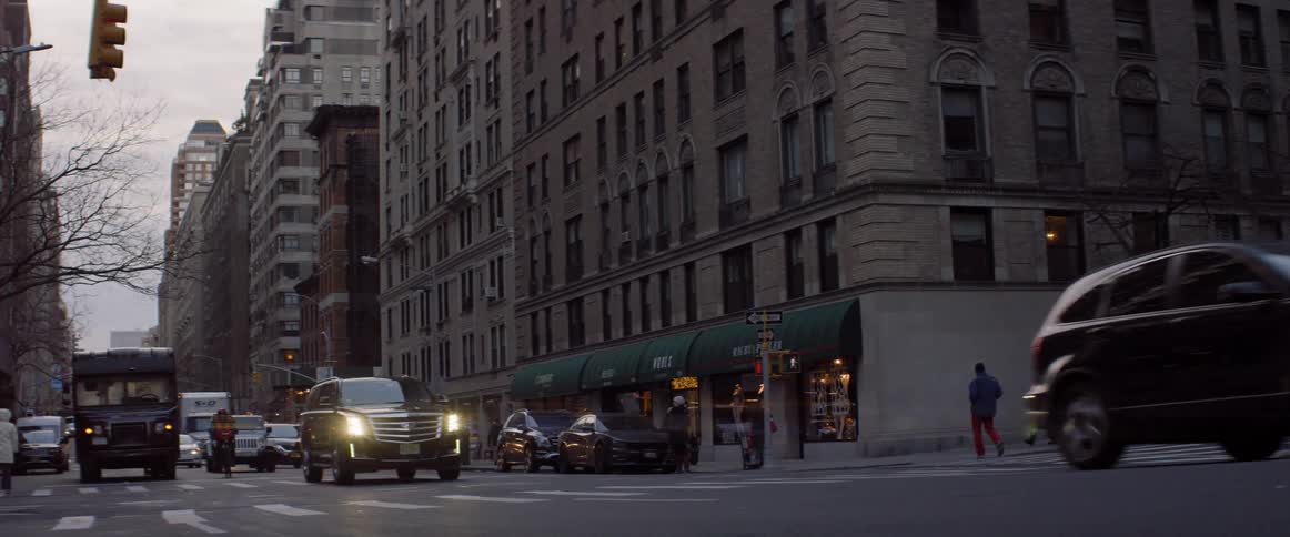 Cars drive on a city street