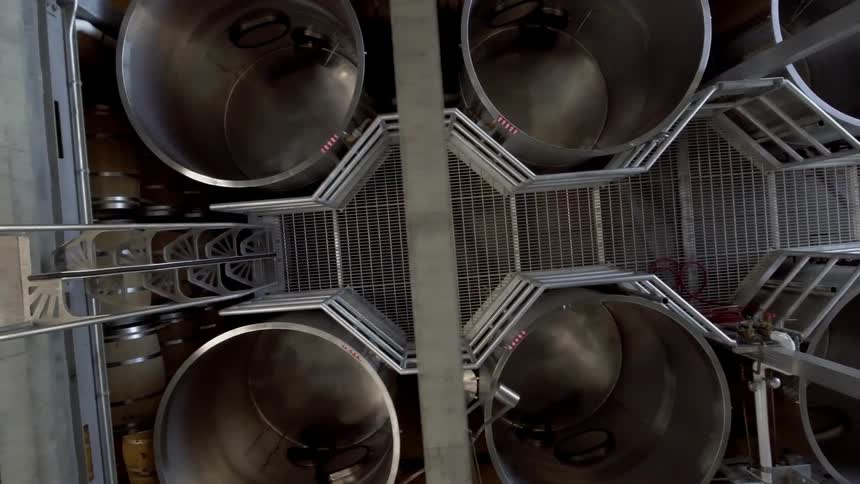 The warehouse has many metal vats