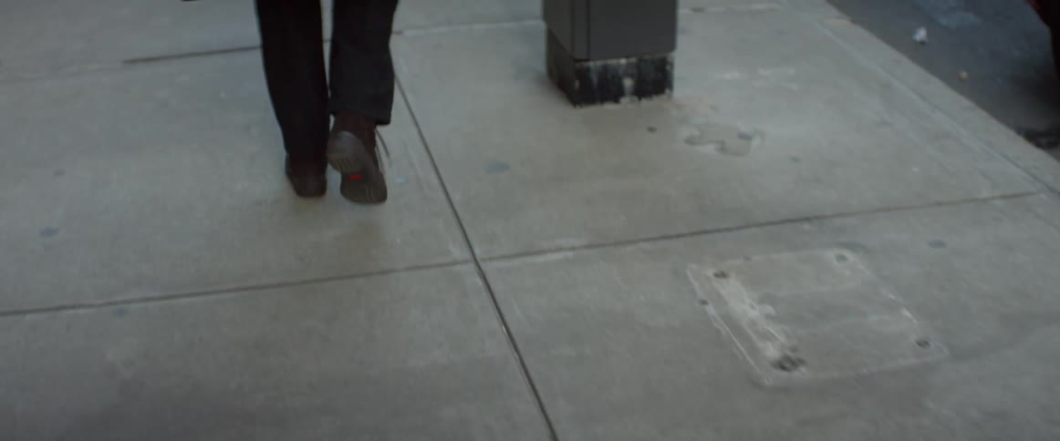 A person is walking down the sidewalk