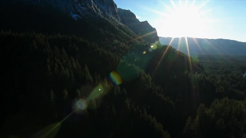 A lush green valley is being filmed from a drone