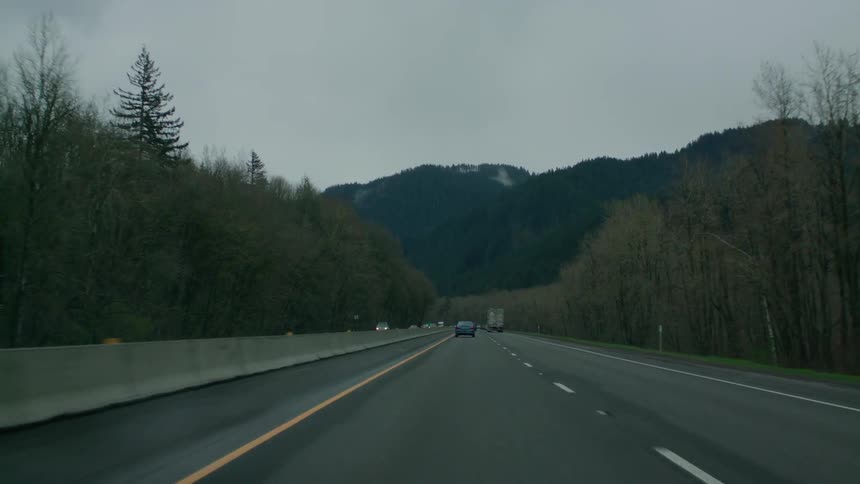 Vehicles travel down a mountain highway