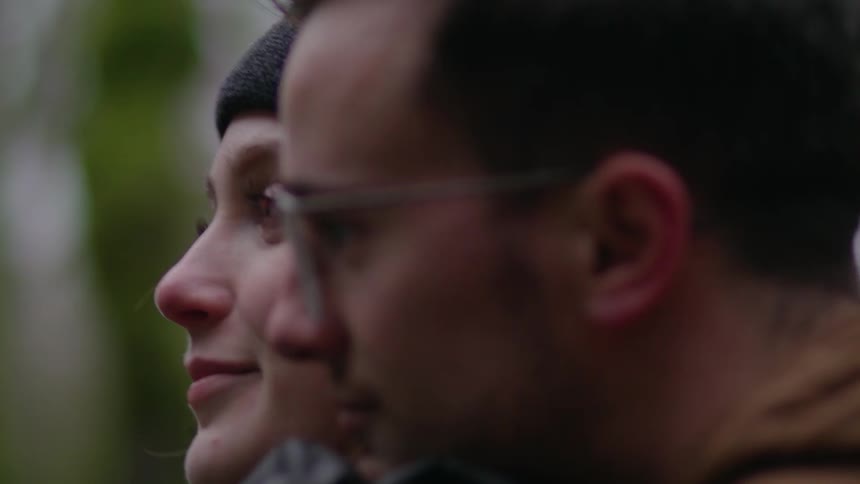 A man embraces a smiling woman