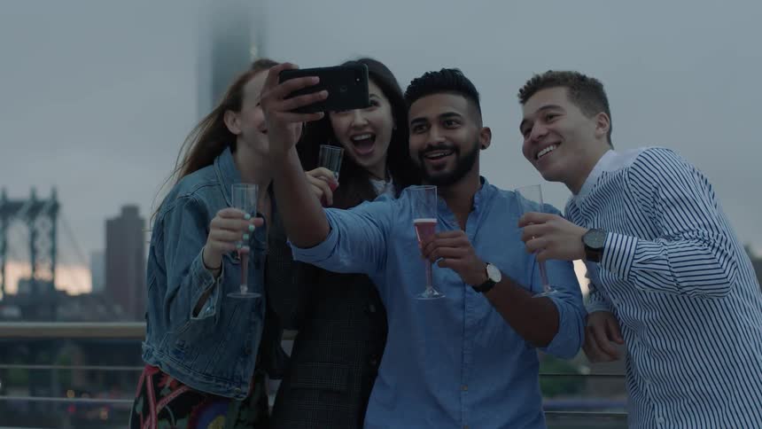 A group of young people take a group photo