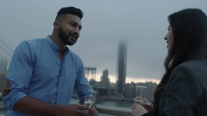 A man and woman talk and drink