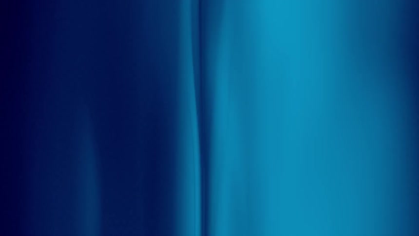 Blue water ripples as a shadow crosses it