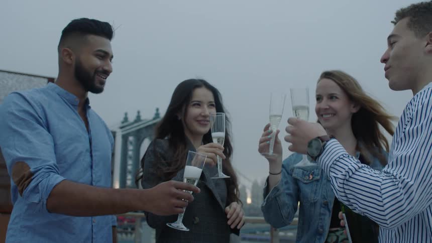 Two couples raise champagne glasses in toast