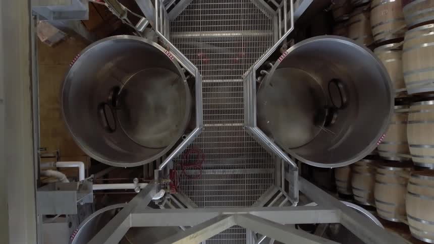 Aerial view of large metal barrels in a factory