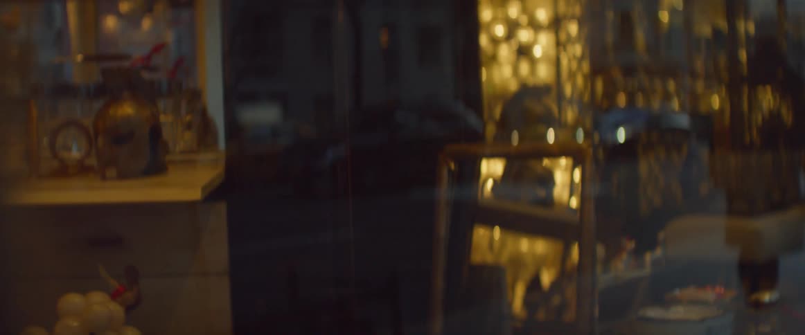 Moving traffic and people walking is reflected in a store window
