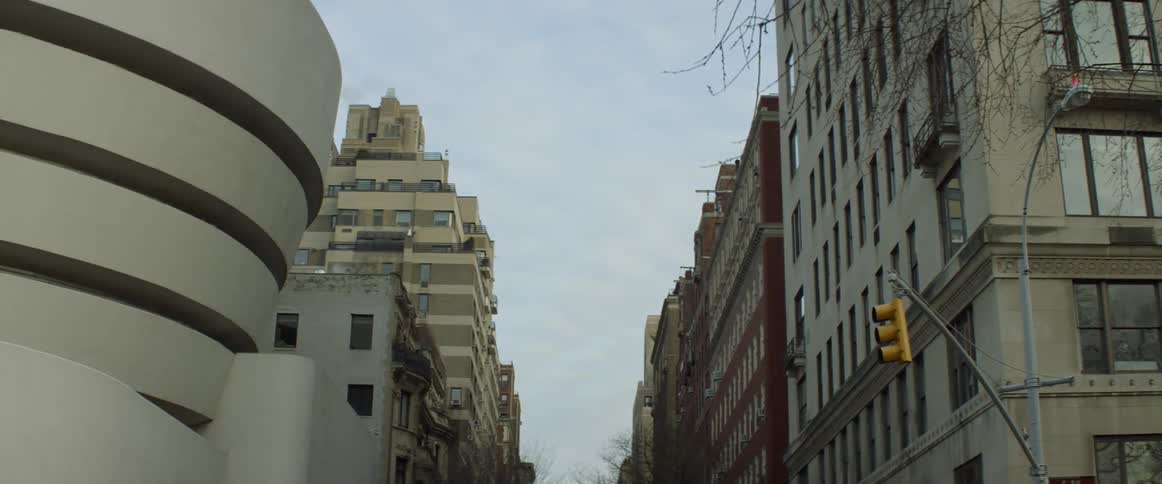 Bus passing by tall buildings