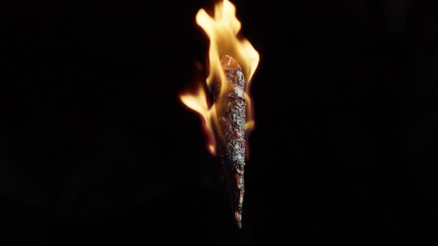 A flaming chili pepper roasting