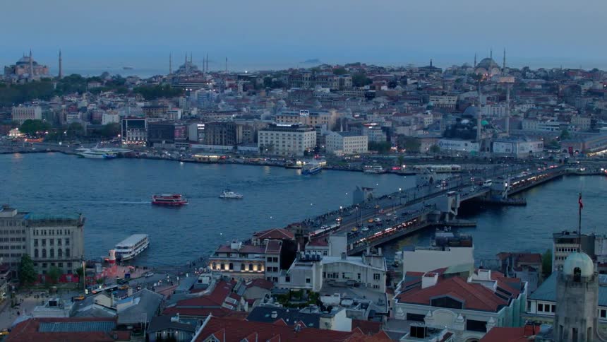 Boats travel down the river towards a bridge