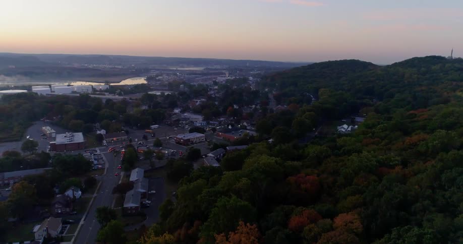 The town is near a hillside covered with trees