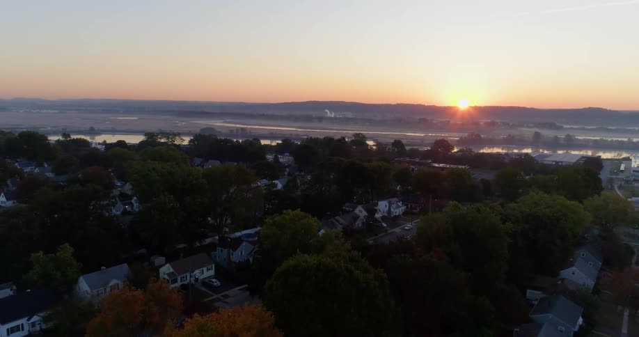 The sun sets over a neighborhood
