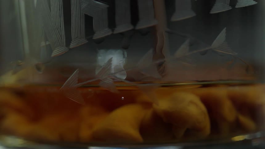 Oil is being poured into vinegar and a reaction is happening