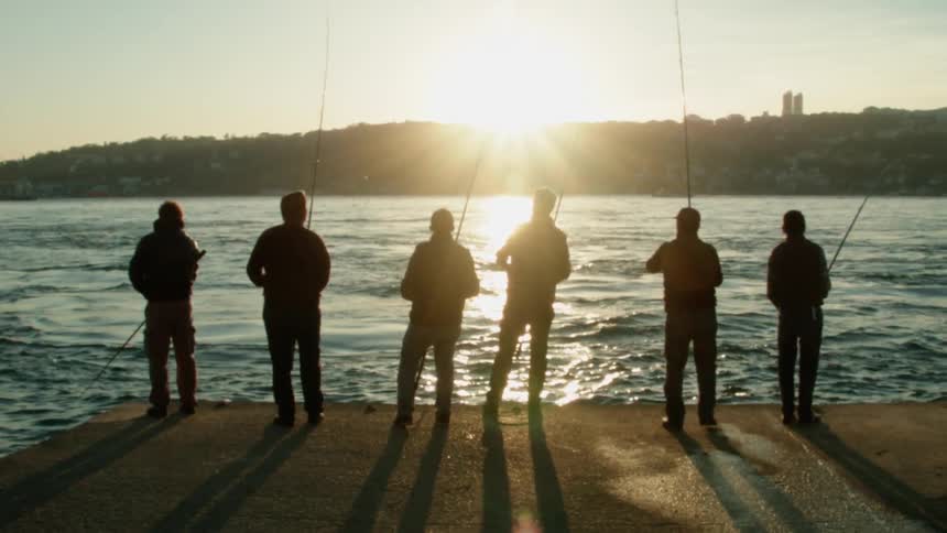 Men fish off of a dock