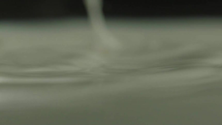 White liquid drops into the pool