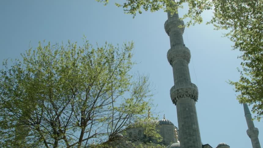 Tall sculpture outside of a building on a sunny day